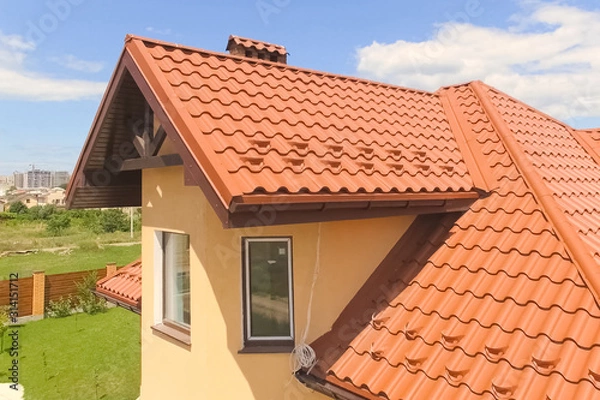 Fototapeta House with a new roof made of orange metal. View from above. Cor