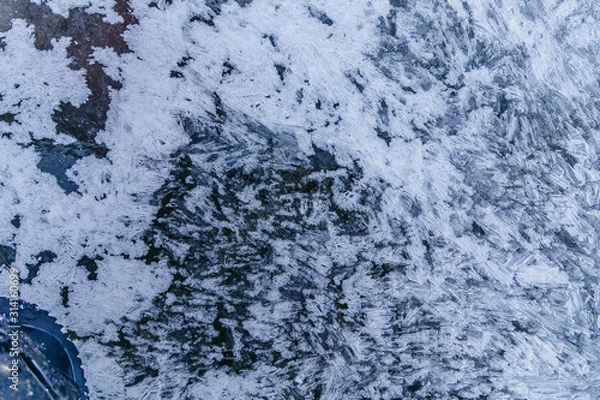 Fototapeta Ice texture, interesting frozen lake patterns, naturally created forms. Frozen river's water in the winter in mount Vitosha, near Sofia, Bulgaria. Ice Age climate changes.