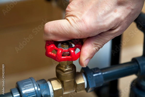 Obraz Hand spins valve close-up