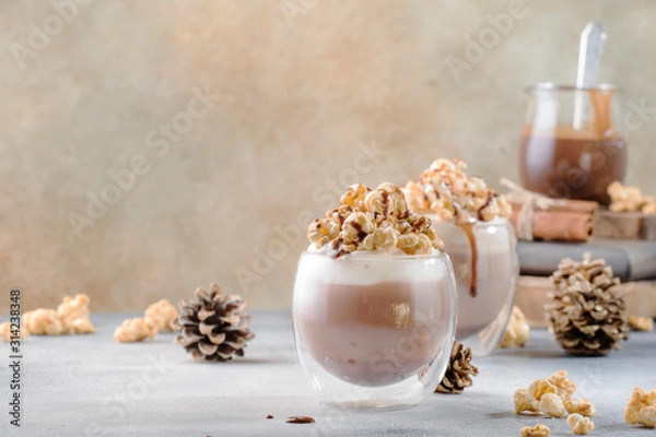 Fototapeta Cold chocolate dessert with whipped cream, popcorn and caramel topping in glasses on beige background, place for text