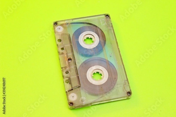 Fototapeta Old audio cassettes located on a green background