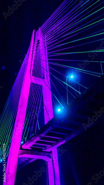 Fototapeta Mahkota bridge in Samarinda, Indonesia at night with beautiful lights. It cross Mahakam river.