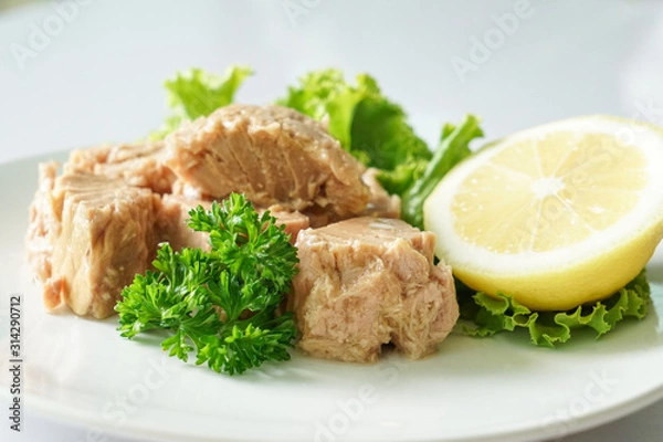 Fototapeta Tuna chunk on white plate.