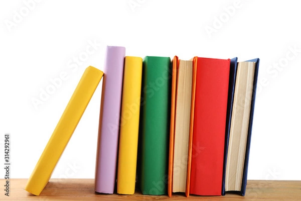 Fototapeta Stack of colorful books on wooden table against white background
