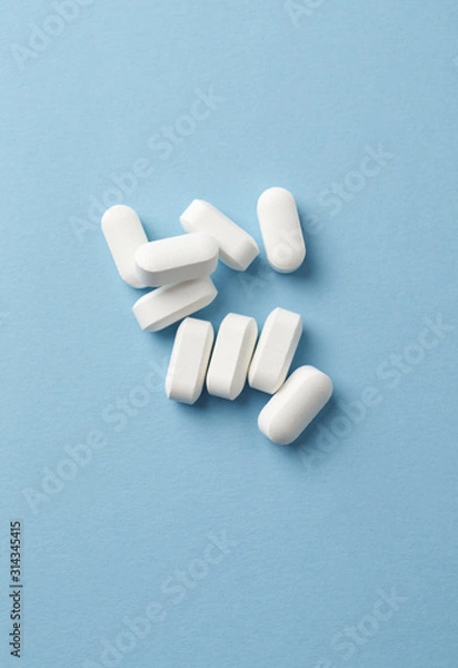 Fototapeta BCAA amino acids. Nutrition for bodybuilding. Fitness supplements on bright paper background. Top view. Copy space. 