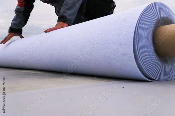 Fototapeta Rolls of polymer coating for roof. Deployment of a roof covering roll.