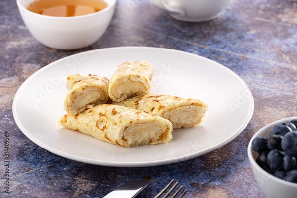 Obraz Homemade pancakes with cream cheese and berry jam on a plate, selective focus