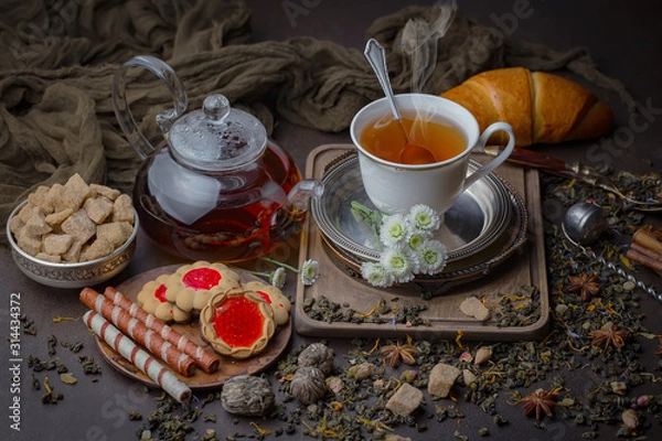 Fototapeta Tea hot drink on old background in composition on the table