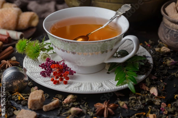 Fototapeta Tea hot drink on old background in composition on the table