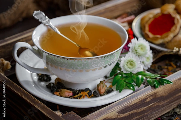 Fototapeta Tea hot drink on old background in composition on the table