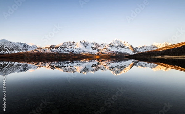 Obraz Beautiful reflection of snow covered mountains at a lake in northern norway at sunrise