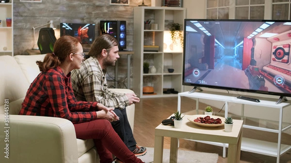 Obraz Couple relaxing on sofa after a hard day at work