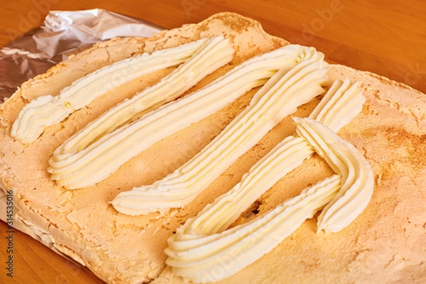 Obraz butter cream squeezed out of a pastry syringe lies on the cake