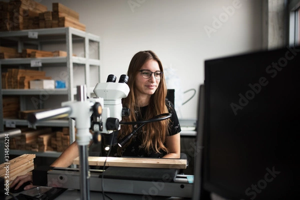 Fototapeta Young beautiful woman work in students laboratory. Student working in lab. 