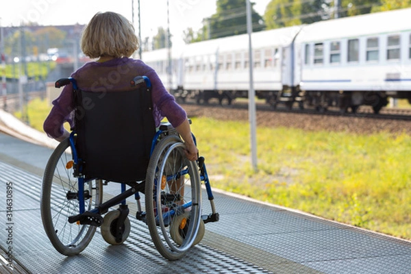 Obraz woman sitting on wheelchair on a platform