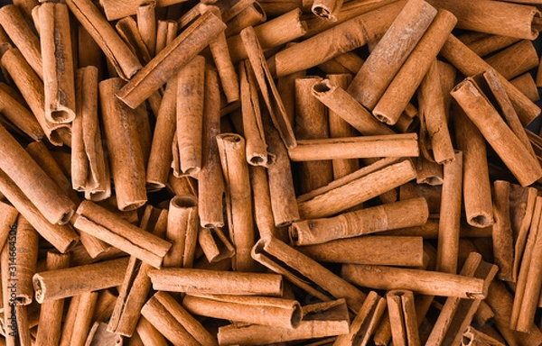 Obraz Cinnamon background. Pile of cinnamons stick top view.