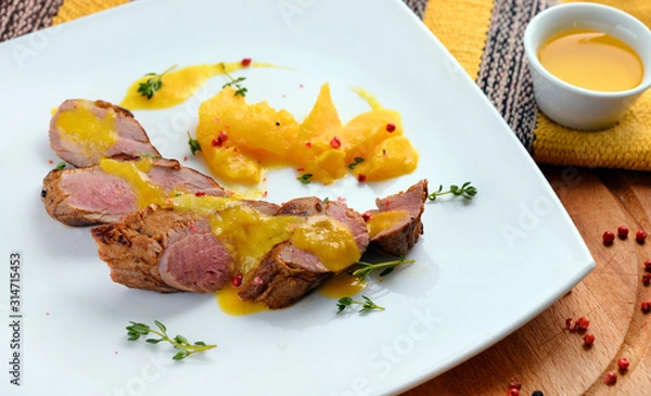 Fototapeta Meat, steak, poultry, duck, roast beef, side dish, thyme on a white plate