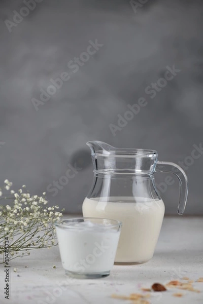 Fototapeta Dairy products, milk, yogurt, sour cream, kefir, in a glass and a jug. Vertical