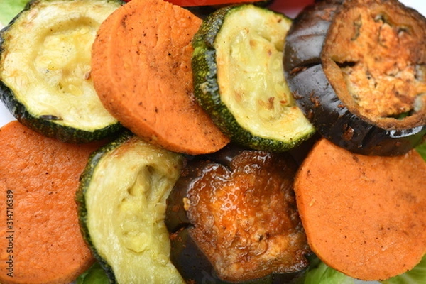 Fototapeta Grilled vegetables, sweet potato, zucchini, eggplant, laid in neat layers, rows. Bright, juicy, macro.