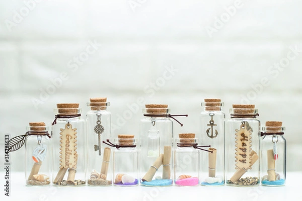 Fototapeta Small shells in many small glass bottles