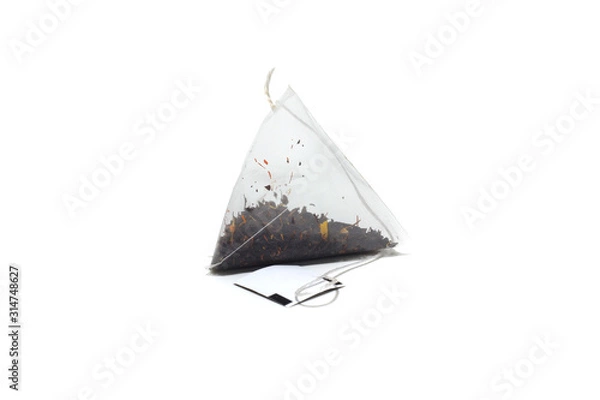 Fototapeta tea bag of black tea with herbs on a white isolated background