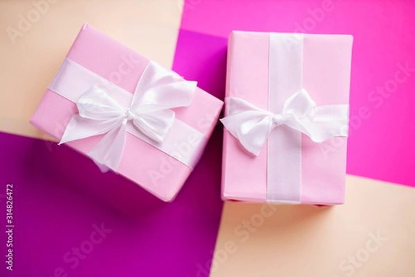 Fototapeta Holiday design template with festive gift boxes wrapped with ribbons. Multicolored background, copy space. Birthday, Valentines, mother's day, celebration concept