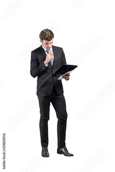 Fototapeta Thoughtful businessman with clipboard, full length