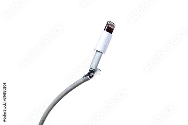 Fototapeta The broken and frayed cable from the charger for the smart phones. Typical problem of the users.