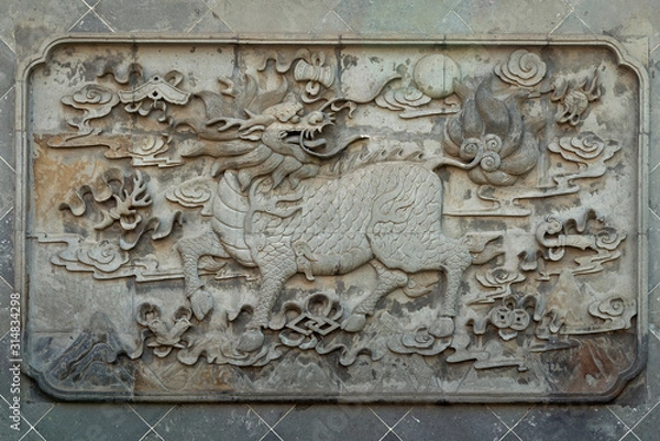Fototapeta Relievo of chimerical creature Kylin on the wall