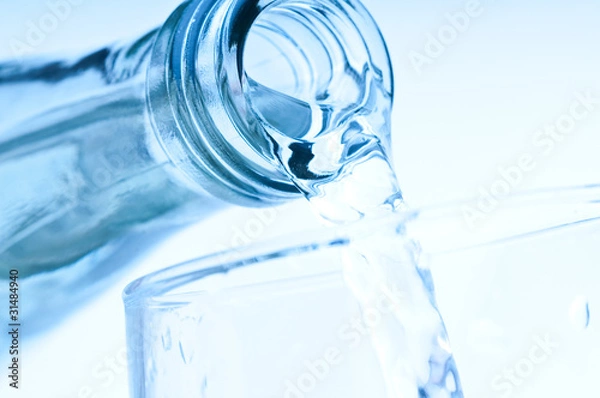 Obraz bottle pouring water into  glass