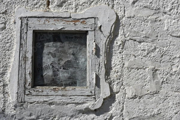 Obraz small window in a white textured old wall