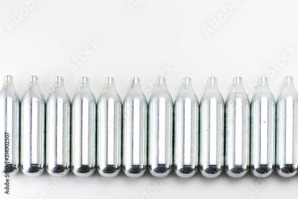 Fototapeta  CO2 metal cylinders for air guns. Lie in a row.