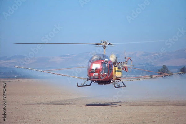 Fototapeta helicopter spraying field
