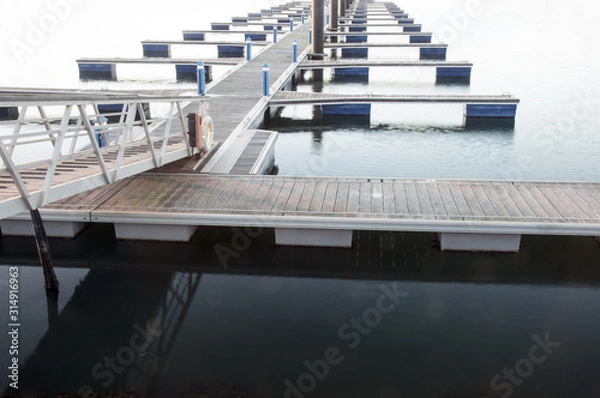 Fototapeta Access to Pantalan from an empty marina in winter lonely urban or marine landscape of non-tourist time