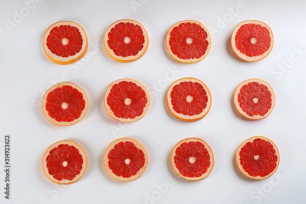 Fototapeta Flat lay composition with tasty ripe grapefruit slices on white background