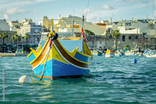Fototapeta A luzzu is a traditional fishing boat from the Maltese islands. Painted in bright colours, luzzus have existed sin