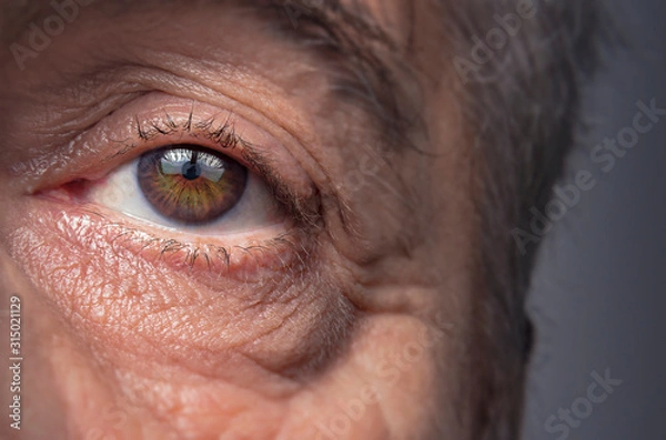 Obraz Close-up view on the eye of senior man.