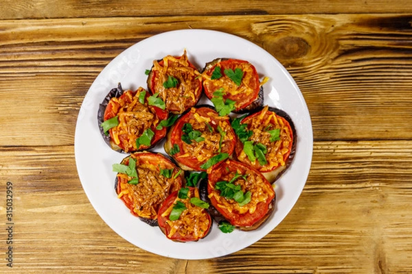 Obraz Baked eggplants with tomatoes and cheese on wooden table. Top view