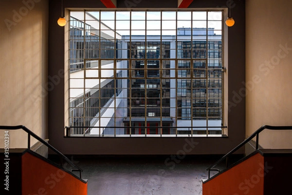Fototapeta Germany, Saxony-Anhalt, Dessau-Rosslau: Bauhaus building interior view with famous glass windows, stairways stairwell, offices, front facade - concept modern architecture art school.