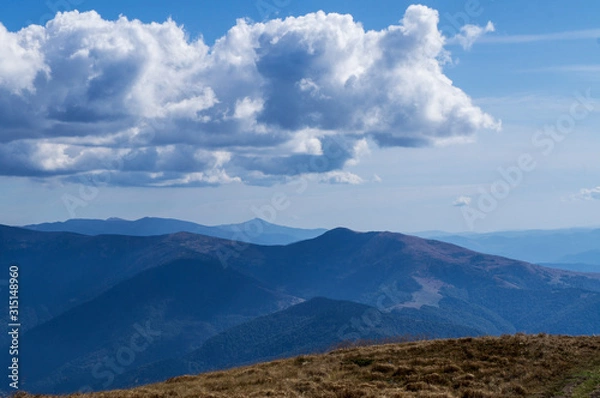 Fototapeta Colorful mountain landscape in the summer mountains. Large hills with blue sky.