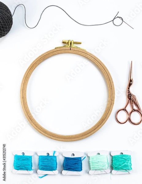 Obraz Embroidery accessories. Multicolored bundles of thread, scissors, sewing needles. White background ready for copywriting.