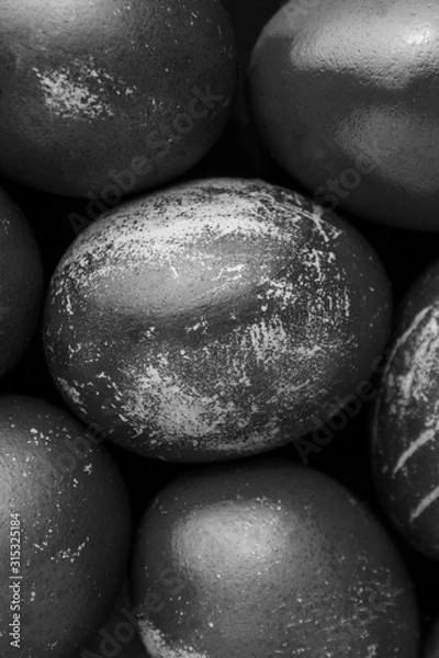 Fototapeta Easter eggs painted in monochrome black and white style close up, with stains, scuffs, scratches. handmade painted eggs. Flat lay