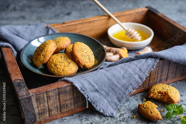 Fototapeta Whole wheat flour cookies with turmeric, sweetened with honey, sprinkled with chia seeds