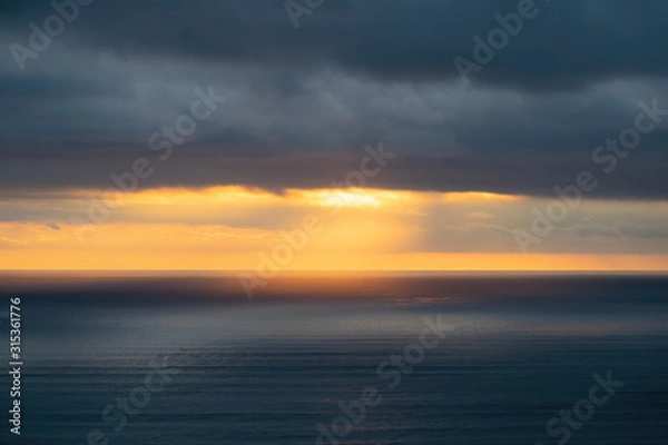 Fototapeta Aerial view of low clouds over Tasman sea at Piha in sunset light