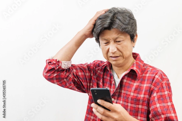 Obraz スマートフォンを見て困った顔をする男性