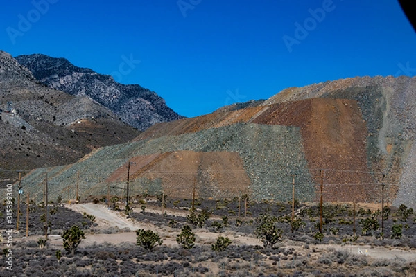 Fototapeta Multiple rock types in aggregate pile on mountain side