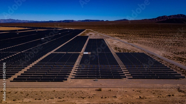 Fototapeta Aerial photos of Solar Farm in Desert with mountains in background