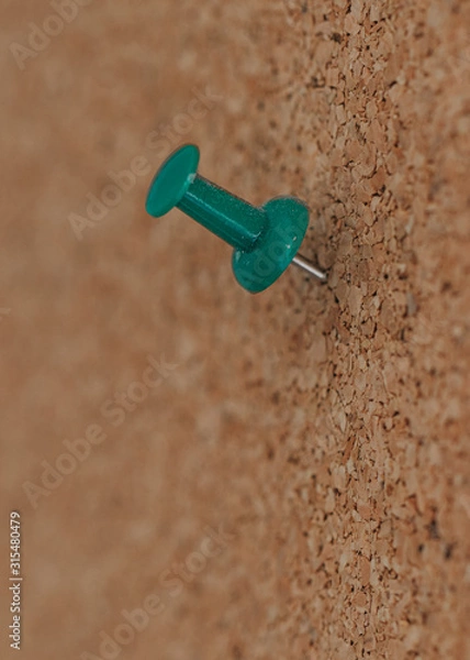 Obraz green pushpin on a cork board