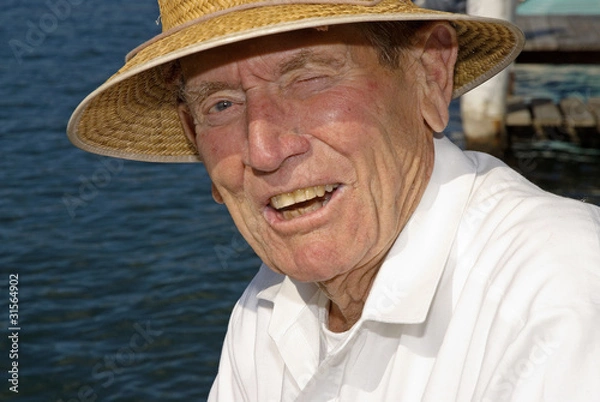 Fototapeta Elderly man winking at the camera