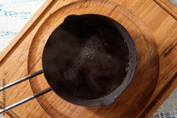 Fototapeta Freshly made black coffee in Turk.